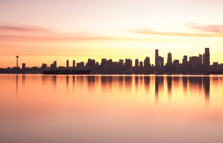 The Seattle skyline at sunset over the water